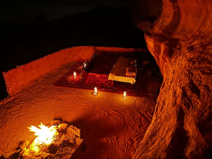 From Wadi Rum: Jeep Tour with Overnight Desert Camping - An open Jeep through Wadi Rum’s red desert