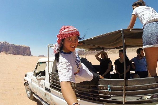 Half-Day Jeep Safari "Wadi Rum Highlights!" w/ Professional Bedouin Guide - Riding the rear bench through the protected area